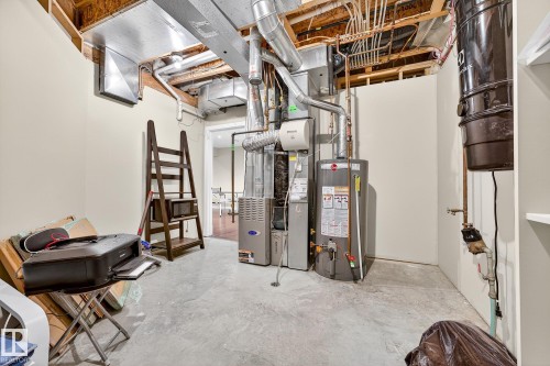 Unfinished basement with gas water heater and heating unit - 940 Haliburton Road, Edmonton, AB - Indoor Photo Showing Basement