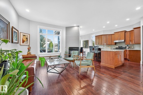 Living area with plenty of natural light, recessed lighting, a fireplace, and dark wood-type flooring - 940 Haliburton Road, Edmonton, AB - Indoor
