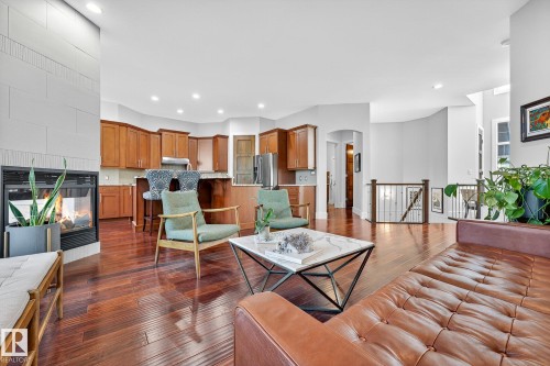 Living area with arched walkways, a fireplace, dark wood-style flooring, and recessed lighting - 940 Haliburton Road, Edmonton, AB - Indoor Photo Showing Living Room