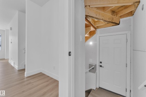 Entryway featuring a paneled door with black hardware, exposed wood framing, and gypsum board walls - 285 Munn Way, Leduc, AB - Indoor Photo Showing Other Room