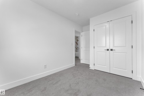 Room featuring gray carpet flooring, white walls, and white baseboards - 285 Munn Way, Leduc, AB - Indoor Photo Showing Other Room