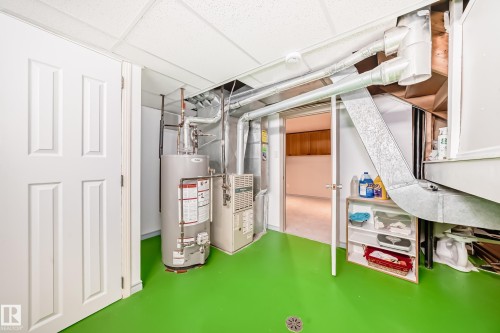 Utility room with a water heater, furnace, and exposed ductwork - 8733 181A Street Nw, Edmonton, AB - Indoor Photo Showing Basement