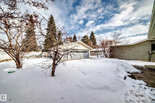 The property includes a detached garage with a light-colored exterior and a two-car garage door - 8733 181A Street Nw, Edmonton, AB - Outdoor