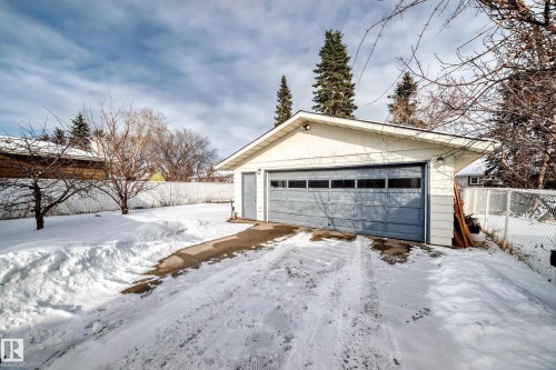Detached garage with a light blue sectional garage door and a white exterior finish - 8733 181A Street Nw, Edmonton, AB - Outdoor