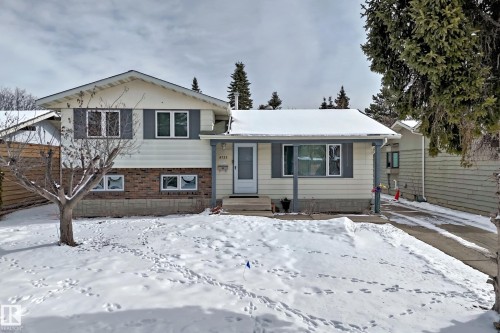 The property features an exterior of light-colored siding and brick accents, with a gabled roofline - 8733 181A Street Nw, Edmonton, AB - Outdoor