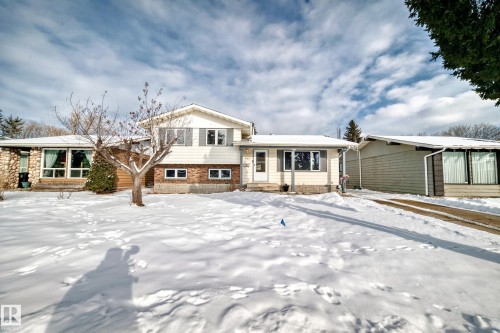The property features a split-level design with white siding and a brick base - 8733 181A Street Nw, Edmonton, AB - Outdoor