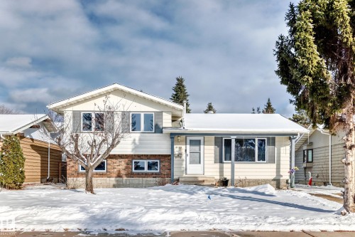 The property features a two-story design with a brick and siding exterior, complemented by a covered porch at the entrance - 8733 181A Street Nw, Edmonton, AB - Outdoor With Facade