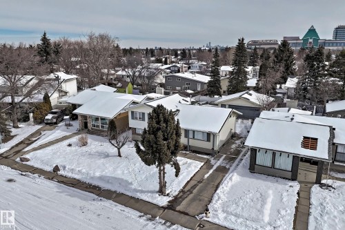 This property features a well-maintained exterior with a driveway leading to a garage - 8733 181A Street Nw, Edmonton, AB - Outdoor