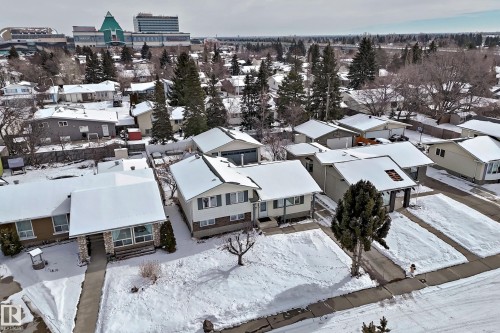 An aerial view highlighting the surrounding residential area and the property's proximity to a prominent building in the distance - 8733 181A Street Nw, Edmonton, AB - Outdoor
