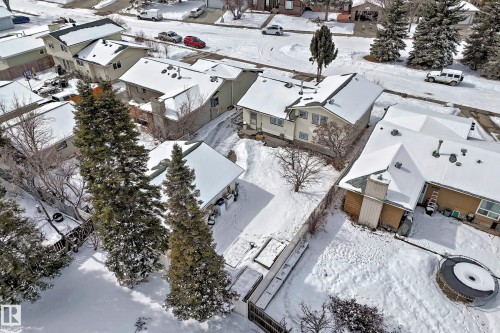 Aerial view of the property with a visible yard and mature trees, located within a neighborhood featuring residential streets and other properties - 8733 181A Street Nw, Edmonton, AB - Outdoor