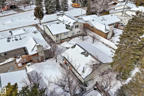 Aerial view of the property and its surrounding neighborhood, featuring snow-covered rooftops and trees - 8733 181A Street Nw, Edmonton, AB - Outdoor
