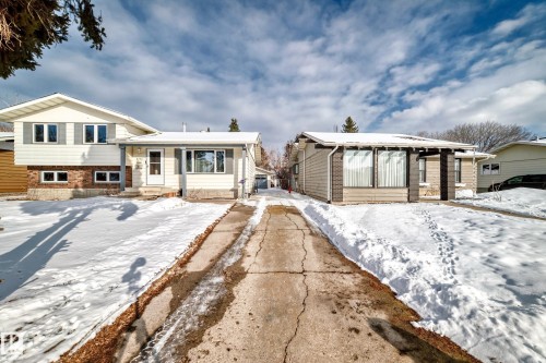 The property features a white exterior with grey shutters and a brick facade - 8733 181A Street Nw, Edmonton, AB - Outdoor With Facade