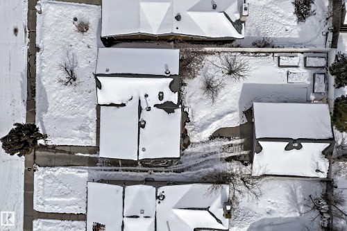 Aerial view of the property and surrounding neighborhood, featuring snow-covered rooftops and grounds - 8733 181A Street Nw, Edmonton, AB - Outdoor