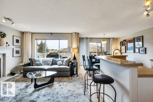 23 211 Blackburn Drive E, Edmonton, AB - Indoor Photo Showing Living Room With Fireplace