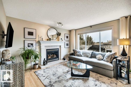 23 211 Blackburn Drive E, Edmonton, AB - Indoor Photo Showing Living Room With Fireplace