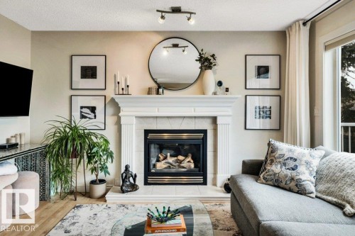 23 211 Blackburn Drive E, Edmonton, AB - Indoor Photo Showing Living Room With Fireplace