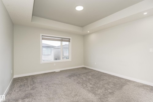 Spacious interior room featuring light gray walls and plush gray carpeting - 5386 Kimball Place, Edmonton, AB - Indoor Photo Showing Other Room