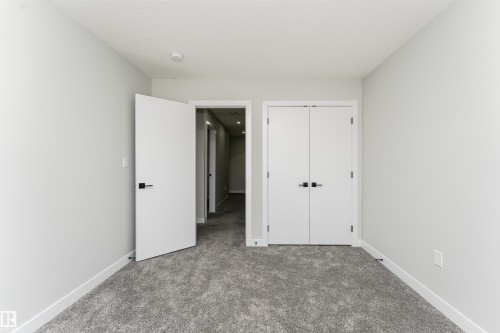 Room featuring light gray wall paint, textured gray carpet, white baseboards, and a flat white ceiling - 5386 Kimball Place, Edmonton, AB - Indoor Photo Showing Other Room