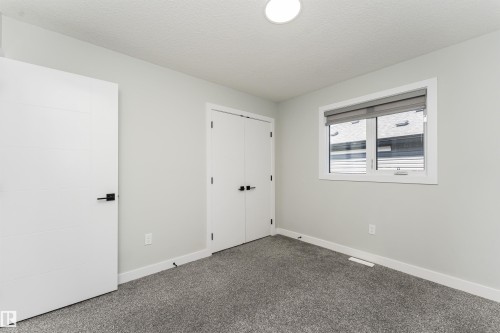 Neutral toned room featuring contemporary light gray walls, dark gray carpeting, and white trim - 5386 Kimball Place, Edmonton, AB - Indoor Photo Showing Other Room
