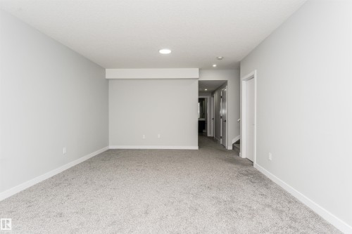 Spacious room featuring light gray carpeting and white baseboards - 5386 Kimball Place, Edmonton, AB - Indoor Photo Showing Other Room