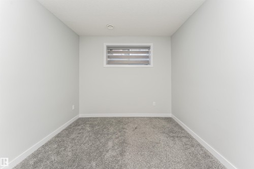 Neutral-toned room featuring a window with horizontal blinds, overhead recessed lighting, light gray walls, white baseboards, and gray carpeting - 5386 Kimball Place, Edmonton, AB - Indoor Photo Showing Other Room