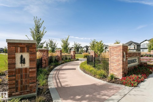 Brick entry monument featuring a decorative tree emblem and "KESWICK" signage - 5386 Kimball Place, Edmonton, AB - Outdoor