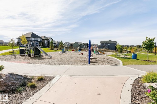 Community park featuring a large play structure with slide, swings, and climbing elements - 5386 Kimball Place, Edmonton, AB - Outdoor