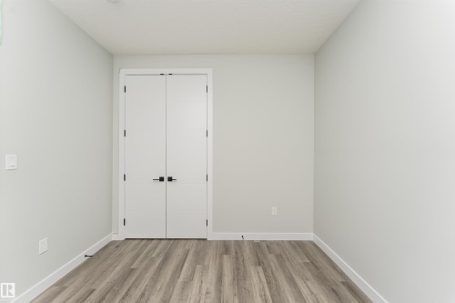 Double panel doors with matte black hardware - 5386 Kimball Place, Edmonton, AB - Indoor Photo Showing Other Room