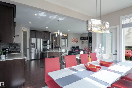 Dining area featuring a contemporary chandelier and expansive window - 1728 53 Street, Edmonton, AB - Indoor Photo Showing Other Room