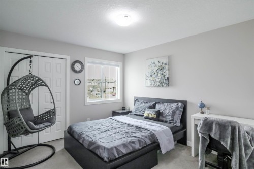 Bedroom featuring light gray wall paint, recessed lighting, and a window with white trim - 1728 53 Street, Edmonton, AB - Indoor Photo Showing Bedroom