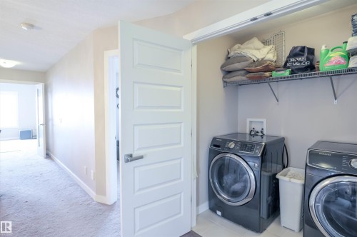 Dedicated laundry area featuring a tile floor, wire shelving, and connections for appliances - 1728 53 Street, Edmonton, AB - Indoor Photo Showing Laundry Room
