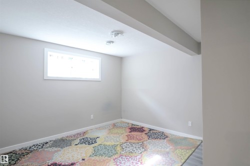 Recessed lighting illuminating a room with neutral-toned walls and white trim - 1728 53 Street, Edmonton, AB - Indoor Photo Showing Other Room