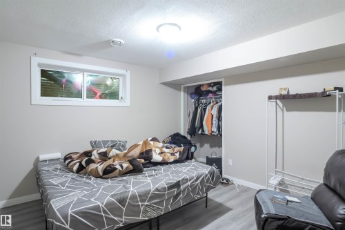 Bedroom featuring a window, recessed lighting, and an open closet space - 1728 53 Street, Edmonton, AB - Indoor Photo Showing Bedroom