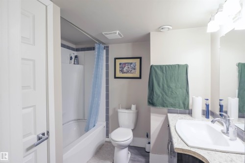 Full bathroom with a white tub-shower combination, a toilet, and a vanity - 1728 53 Street, Edmonton, AB - Indoor Photo Showing Bathroom