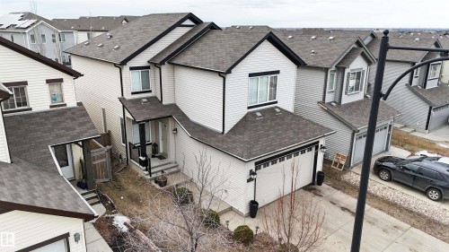 Two-story residence featuring light-colored siding, a dark roof, and contrasting black trim - 1728 53 Street, Edmonton, AB - Outdoor