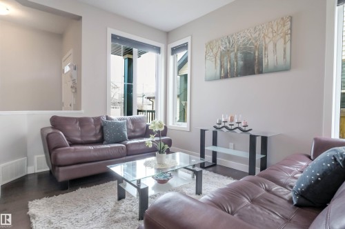 Living area featuring dark wood-finish flooring and light neutral wall paint - 1728 53 Street, Edmonton, AB - Indoor Photo Showing Living Room