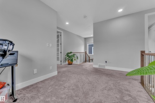 Carpeted hallway with recessed lighting and light gray wall paint - 1404 25 Street, Edmonton, AB - Indoor Photo Showing Other Room