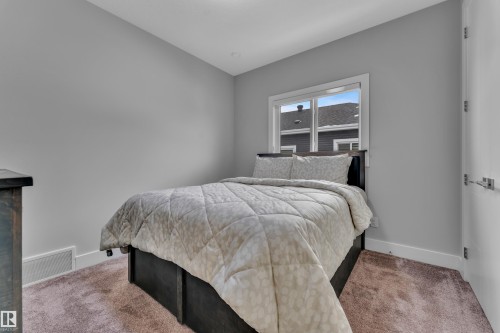 Neutral-toned room featuring a single window with white trim, light gray walls, and brown carpet - 1404 25 Street, Edmonton, AB - Indoor Photo Showing Bedroom