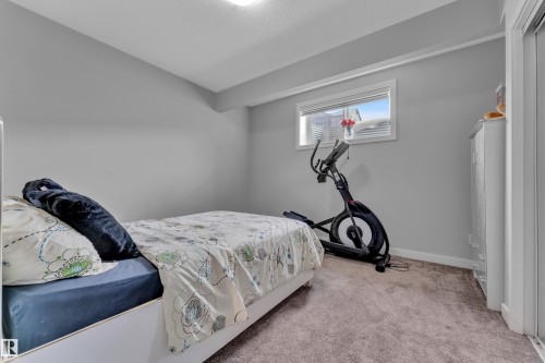 Room featuring light gray painted walls, a single window with white trim, and neutral-toned carpeting - 1404 25 Street, Edmonton, AB - Indoor