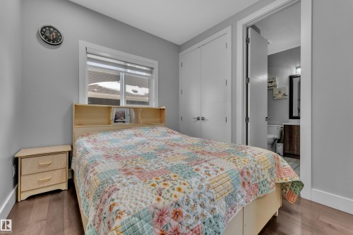 Bedroom featuring wood-finish flooring, a window with blinds, and light gray wall paint - 1404 25 Street, Edmonton, AB - Indoor Photo Showing Bedroom