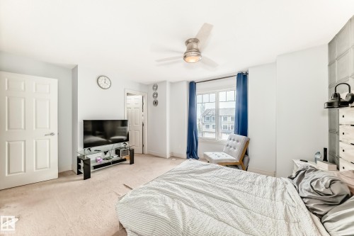 Spacious room featuring light-colored carpet, a ceiling fan with integrated lighting, and multiple interior doors - 69 3625 144 Avenue, Edmonton, AB - Indoor Photo Showing Bedroom