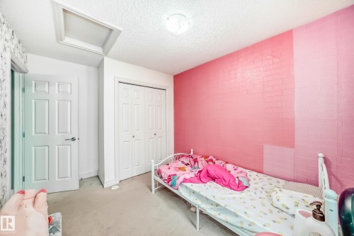 Interior room featuring carpet flooring, a multi-panel door, and a bi-fold closet door - 69 3625 144 Avenue, Edmonton, AB - Indoor Photo Showing Bedroom