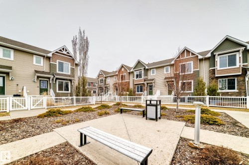 Townhome exteriors featuring horizontal siding, natural stone accents, and gable roofs - 69 3625 144 Avenue, Edmonton, AB - Outdoor