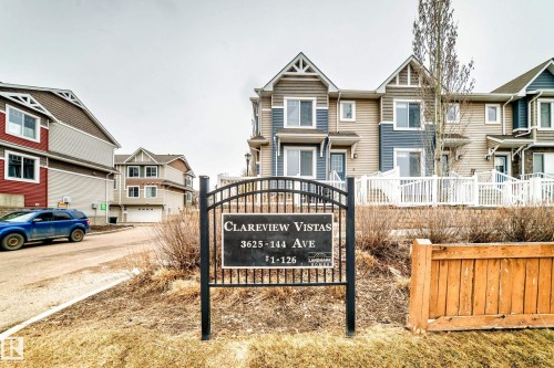 Clareview Vistas townhome community featuring multi-level residences with contrasting siding and white fencing - 69 3625 144 Avenue, Edmonton, AB - Outdoor With Facade