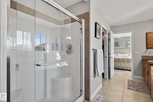 Shower enclosure with clear glass doors and chrome hardware - 1110 Armitage Crescent, Edmonton, AB - Indoor Photo Showing Bathroom