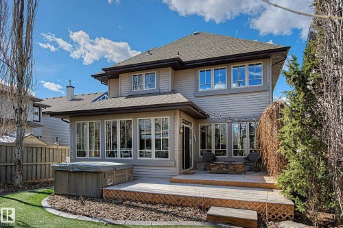 Rear exterior featuring an expansive wood deck, gas fire pit area, and a hot tub - 1110 Armitage Crescent, Edmonton, AB - Outdoor With Deck Patio Veranda