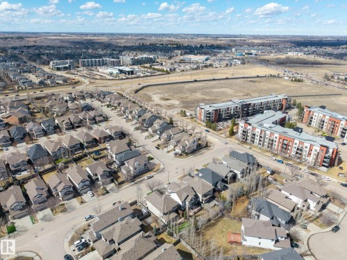 Aerial perspective showcasing a residential area with varied housing types, including single-family homes and multi-story apartment buildings - 1110 Armitage Crescent, Edmonton, AB - Outdoor With View