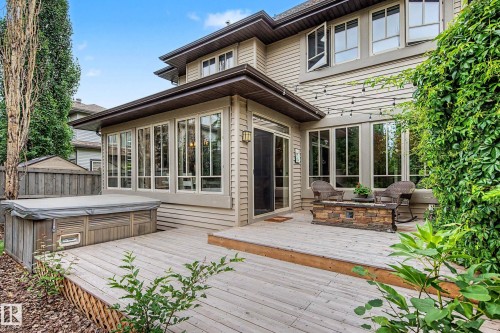 Expansive rear multi-level wood deck featuring a spa, and a stone-clad fire table - 1110 Armitage Crescent, Edmonton, AB 