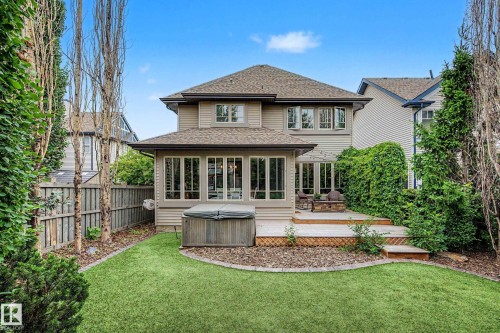 Rear exterior featuring a multi-level wood deck and a landscaped backyard with a manicured lawn - 1110 Armitage Crescent, Edmonton, AB 