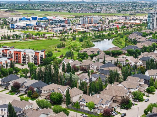 Aerial perspective showcasing a residential neighborhood with diverse housing styles, including single-family homes and multi-story apartment buildings - 1110 Armitage Crescent, Edmonton, AB 